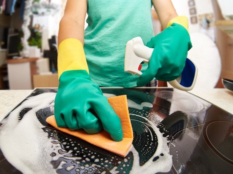 Cleaner working in a Paddington apartment kitchen